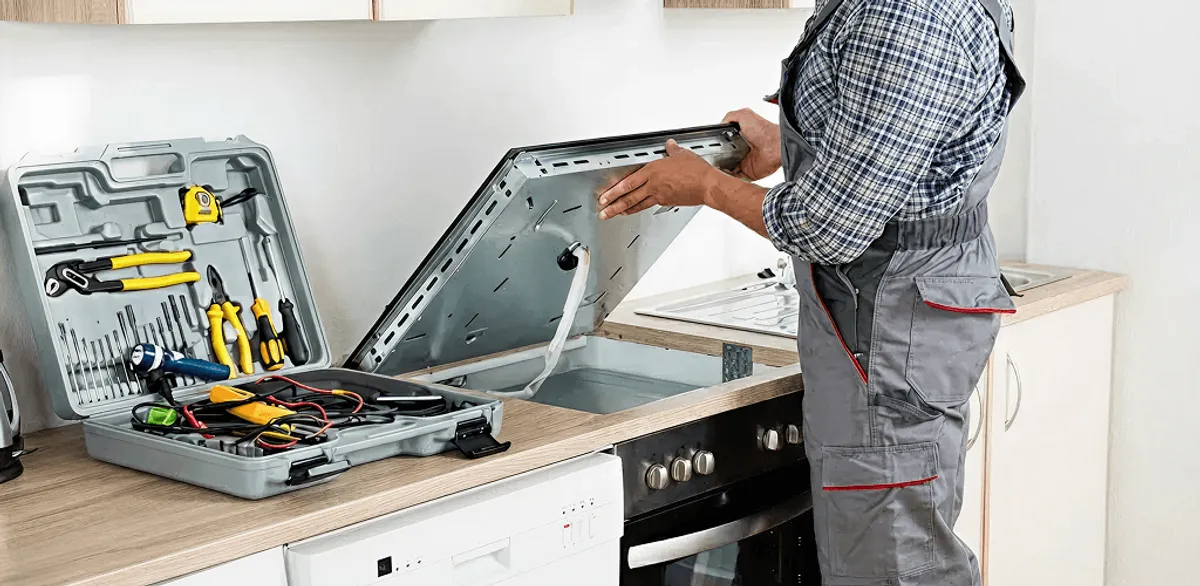Handyman repairing a cooktop and checking wiring connections in Clearwater, FL