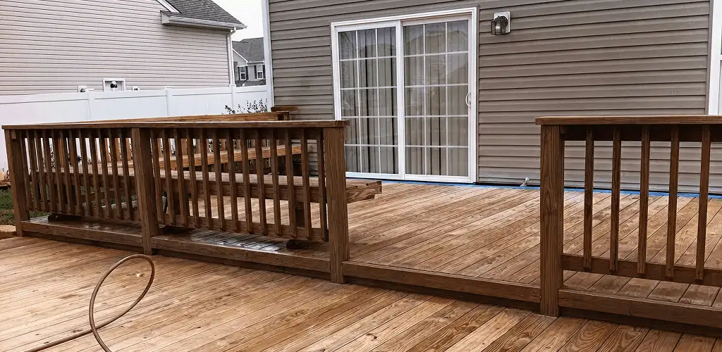 Deck sealing service protecting a backyard wood deck and railings in Clearwater, FL