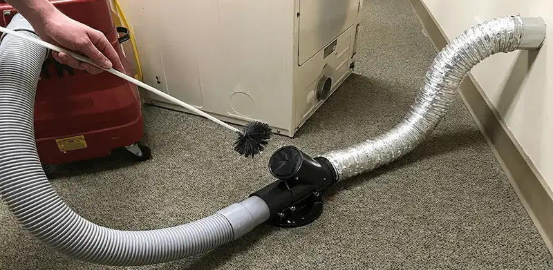 Dryer vent cleaning service removing lint from a dryer duct connection in Clearwater, FL