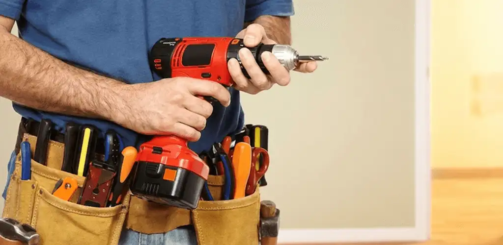 Handyman holding a power drill for home repairs and installations in Clearwater, FL
