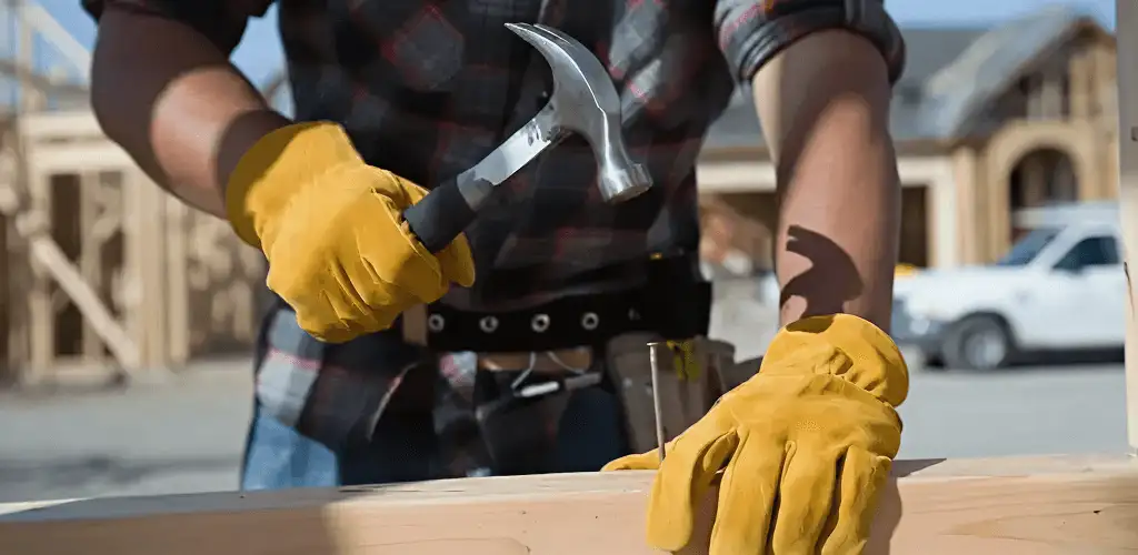 Handyman fixing wood trim with a hammer for home repairs in Clearwater, FL
