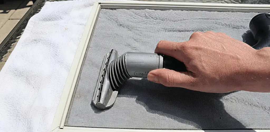 Window screen repair cleaning and fixing a damaged screen mesh in Clearwater, FL