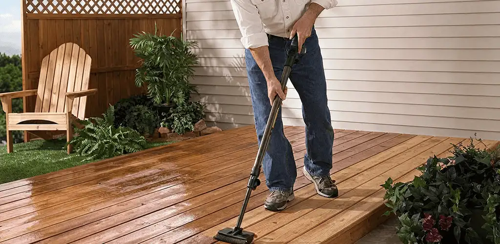 Deck staining service applying stain to a backyard wood deck in Clearwater, FL